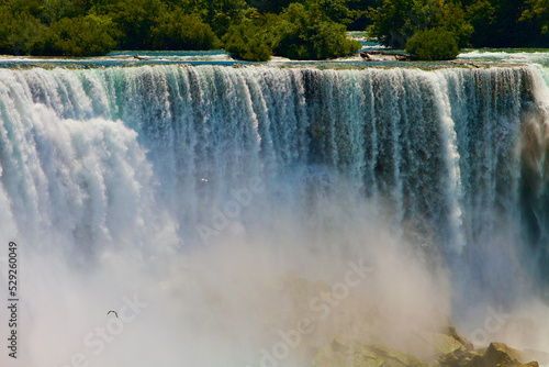 Water flowing over the Bridal Veil Falls and mist rising from the rocks below