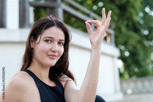 Close portrait of young caucasian woman doing yoga and showing her left hand. Free Download Close portrait of young caucasian woman doing yoga and showing her left hand. - GFXLoad