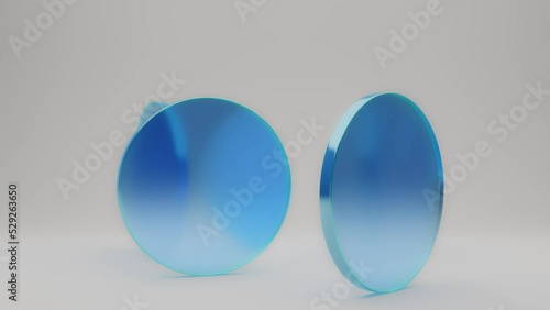 3d render video of circular blue glass pieces rotating on white background