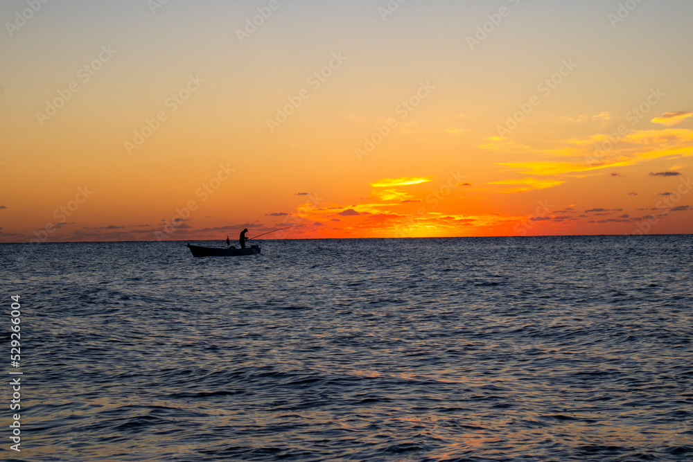 Sunset and fishing boats. setting sun