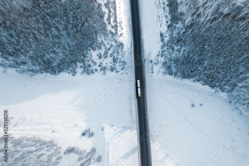 aerial view of a truck driving over a bridge over a river