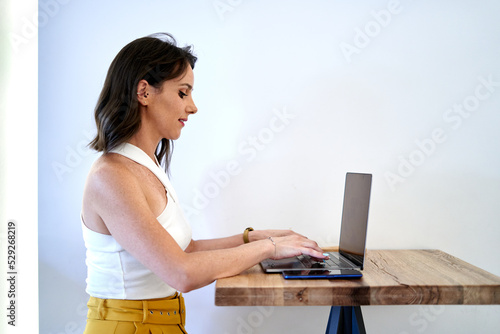 Self employed woman browsing netbook in cafe