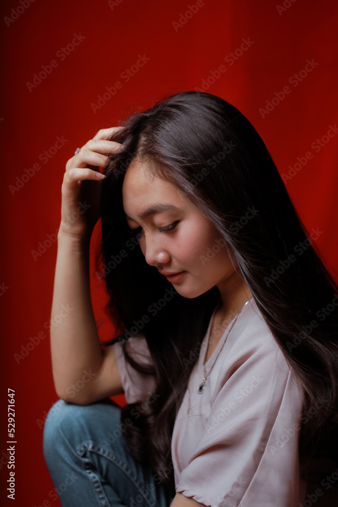 Asian woman taking photo on a red background. Happy Asian woman. Beautiful asian woman with long and straight hair. Asian woman taking photo on a red background. Happy Asian woman. Beautiful asian woman with long and straight hair.