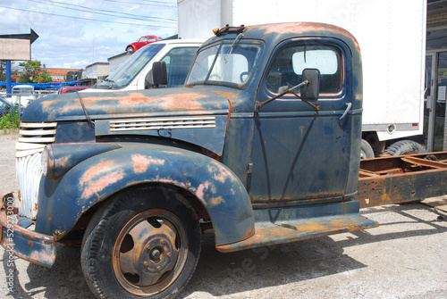 rusty blue old pick up truck in car lot