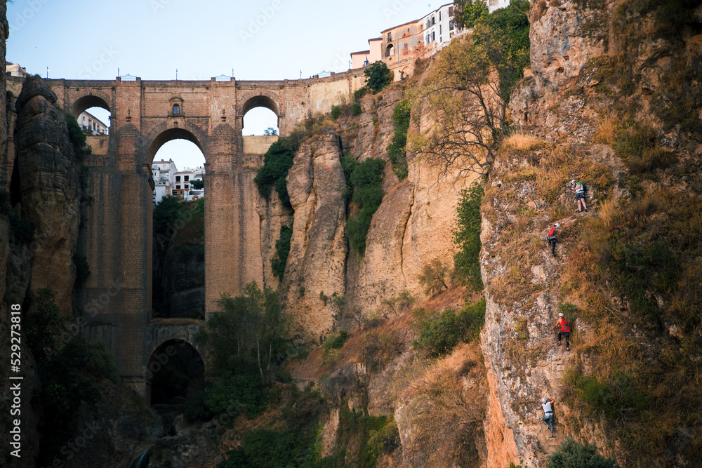 People climbing with the Ronda bridge in the background (Ronda, Andalusia, Spain)
