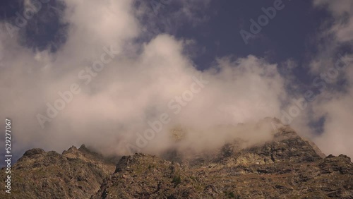 Rocky peaks in the French Alps covered with clouds