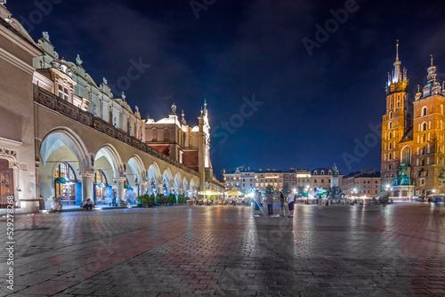 Krakow city in the evening in Poland  Main Square in the Old Town  illuminated St. Mary Church and Cloth Hall  Sukiennice .