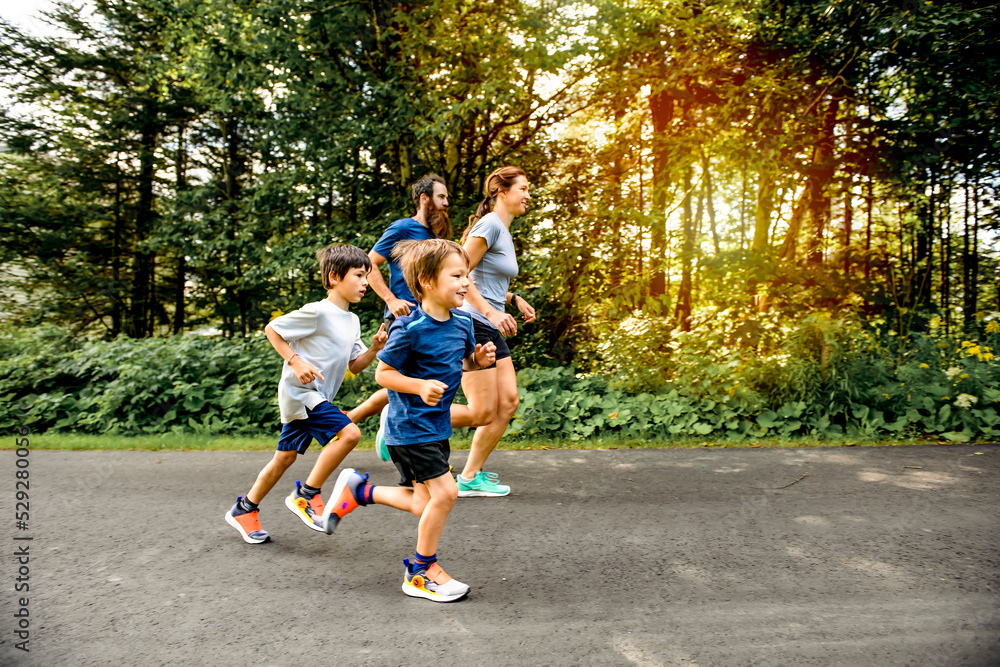 Family exercising and jogging together at an outdoor park Family exercising and jogging together at an outdoor park