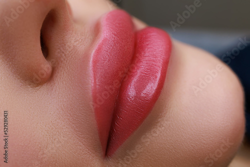 close-up of the lips and with the implementation of permanent makeup using a typewriter