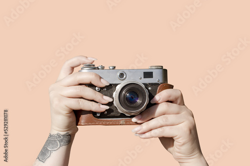 Female hands holding vintage film camera 