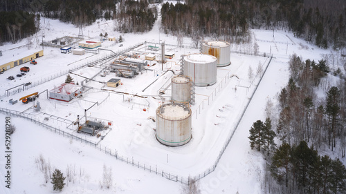 Oil industry. Winter. Booster pumping station for collecting oil and gas with their subsequent transportation to the pipeline. Shooting from a drone. photo