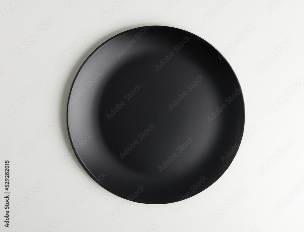 Black plate on an isolated white background. top view Black plate on an isolated white background. top view