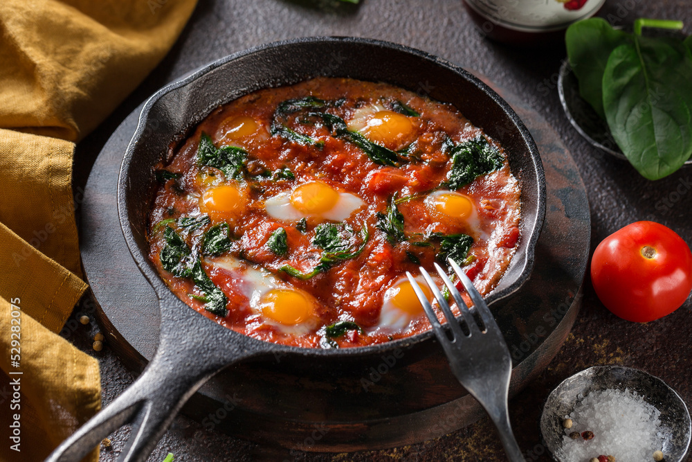Tasty and Healthy Shakshuka in a Frying Pan. Eggs Poached in Spicy Tomato Pepper Sauce. Tasty and Healthy Shakshuka in a Frying Pan. Eggs Poached in Spicy Tomato Pepper Sauce.