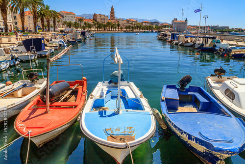 Coastal summer cityscape - view of the boat dock and the Split promenade, the Adriatic coast of Croatia photo