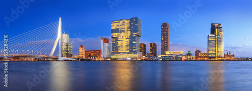 Evening cityscape, panorama, banner - view of Rotterdam with Tower blocks in the Kop van Zuid neighbourhood and Erasmus Bridge, The Netherlands