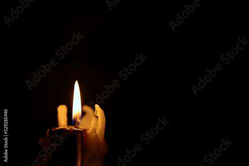Beautiful candles burning against a dark background. the light source.