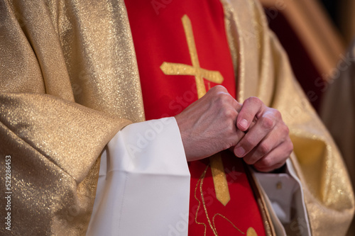 Hands of a Catholic priest in a cassock photo
