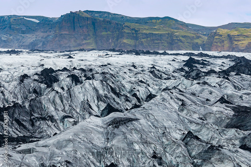 View of people hike tour through Myrdalsjokull Glacier photo