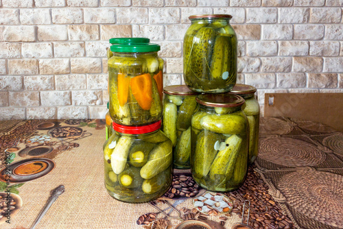 Canned cucumbers in jars on the table