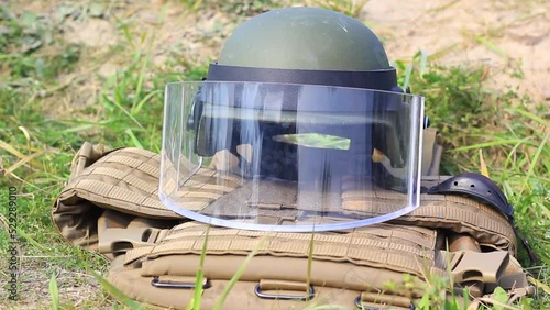 Helmet with plastic glass and body armor close-up