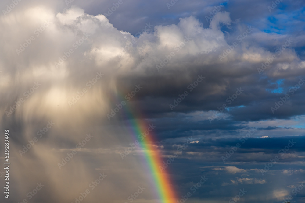 Rainbow colorful sunset on blue pink sky yellow clouds skyline. blue sky with white clouds - perfect for sky replacement	
