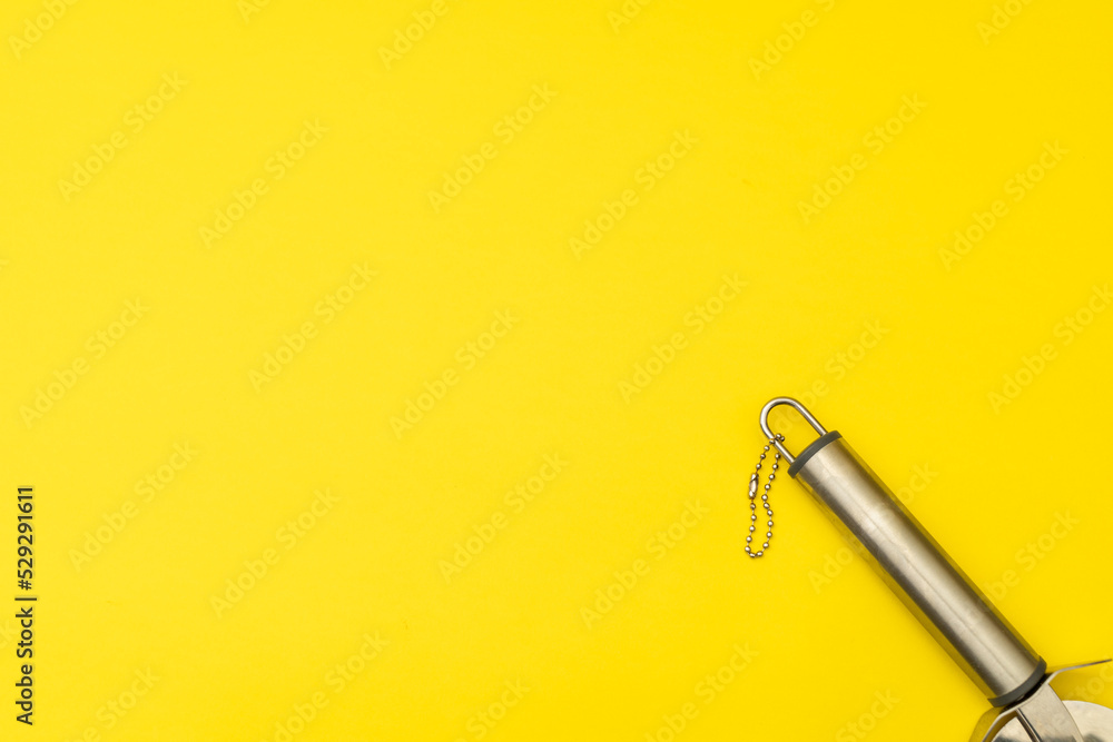 Pizza cutter on yellow background Pizza cutter on yellow background