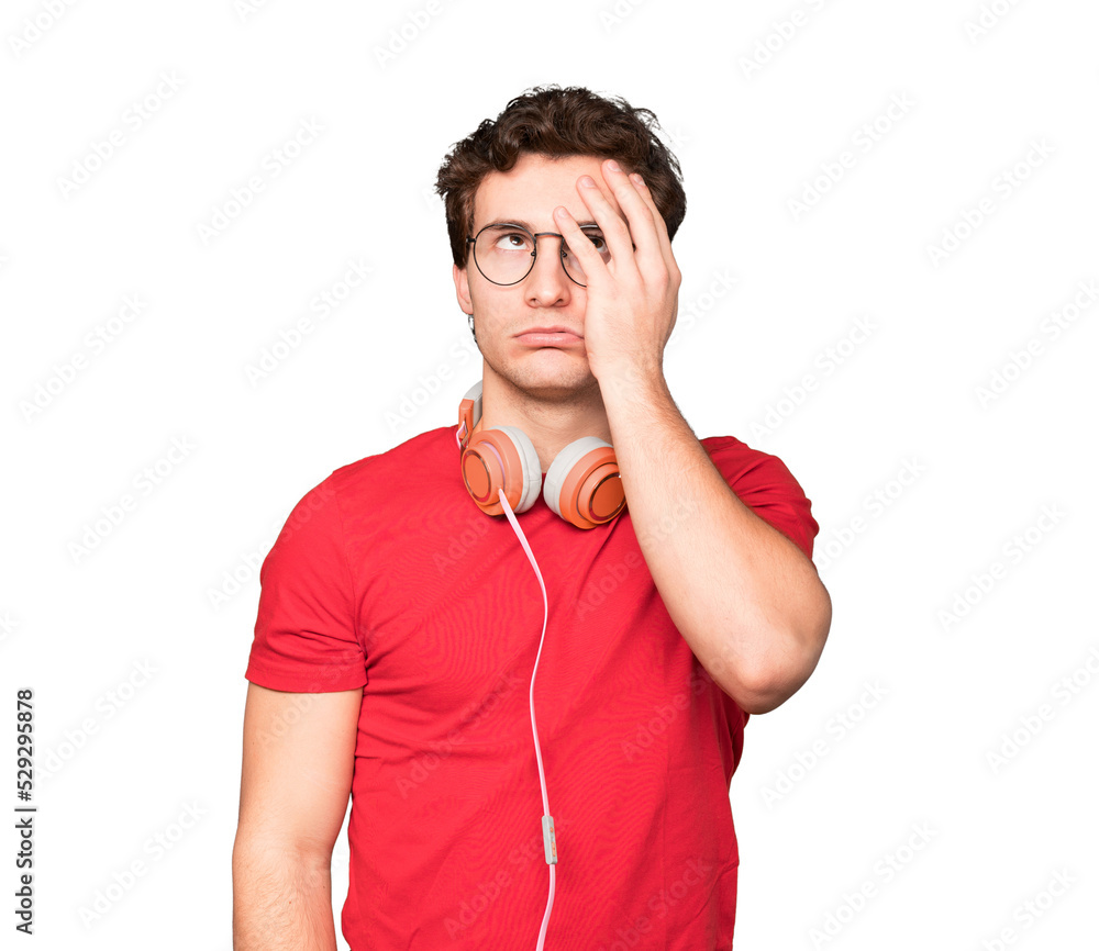 Worried young man using headphones