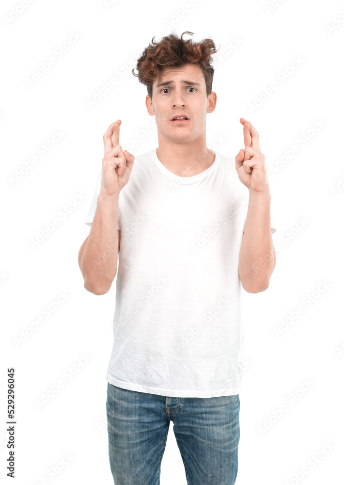 Hopeful young guy with a crossed fingers expression Hopeful young guy with a crossed fingers expression