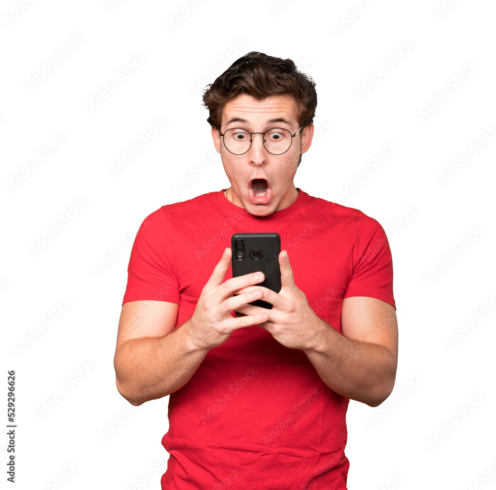 Surprised young man using his mobile phone Surprised young man using his mobile phone