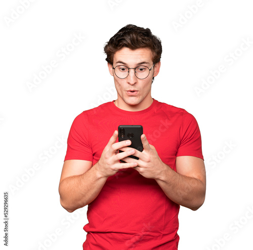 Surprised young man using his mobile phone