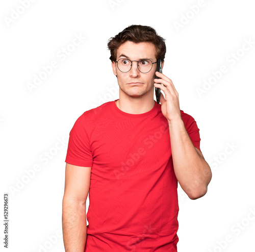 Worried young man using his mobile phone