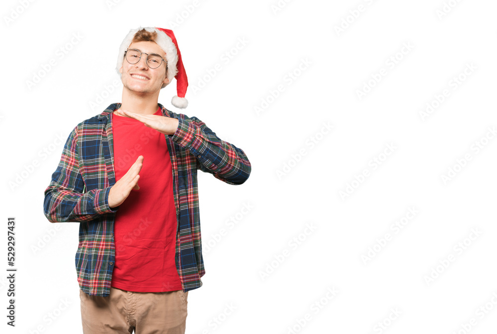 Happy young man at Christmas making a time out gesture with his hands Happy young man at Christmas making a time out gesture with his hands