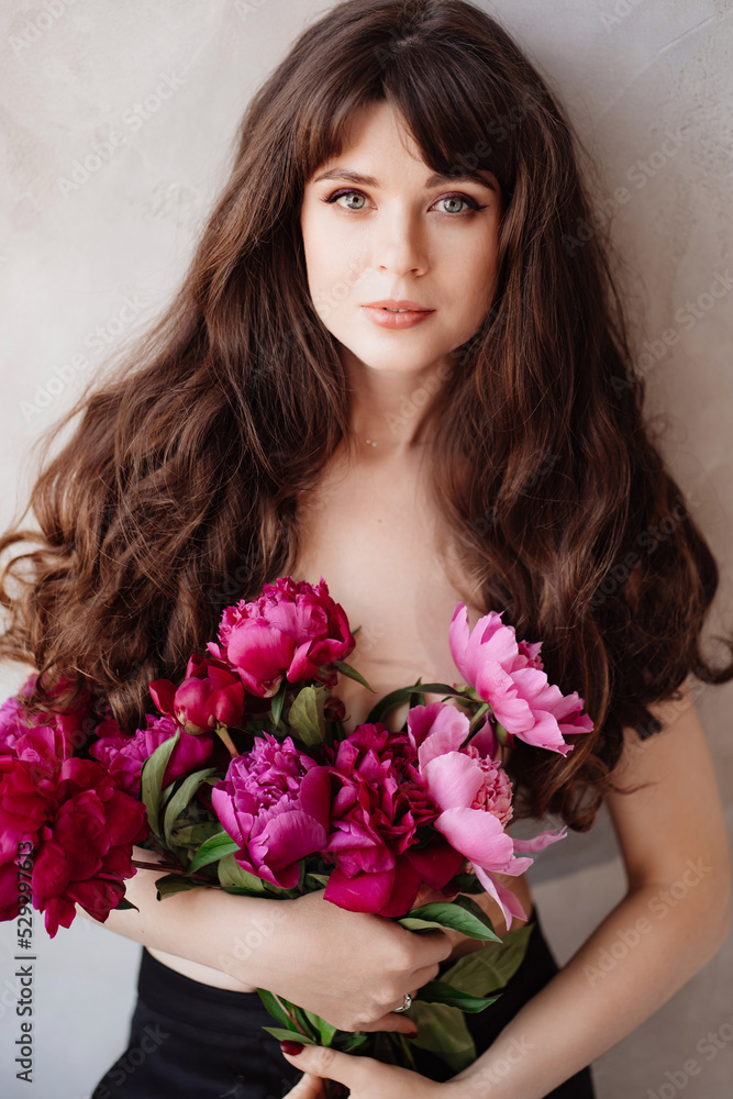 a beautiful woman topless with long hair and a bouquet of peonies. beauty. a beautiful woman topless with long hair and a bouquet of peonies. beauty.