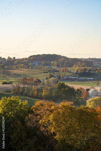 Wooded hills and fields of the Amish country farmland in Holmes County  Ohio  in the late afternoon sunlight in the summer