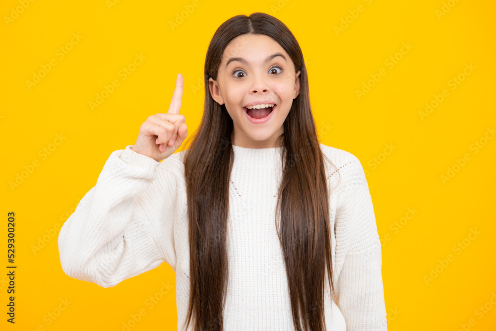 Portrait of cute teenager pointing up with finger. Girl has great new idea. Successful child. Excited face. Amazed expression, cheerful and glad. Portrait of cute teenager pointing up with finger. Girl has great new idea. Successful child. Excited face. Amazed expression, cheerful and glad.