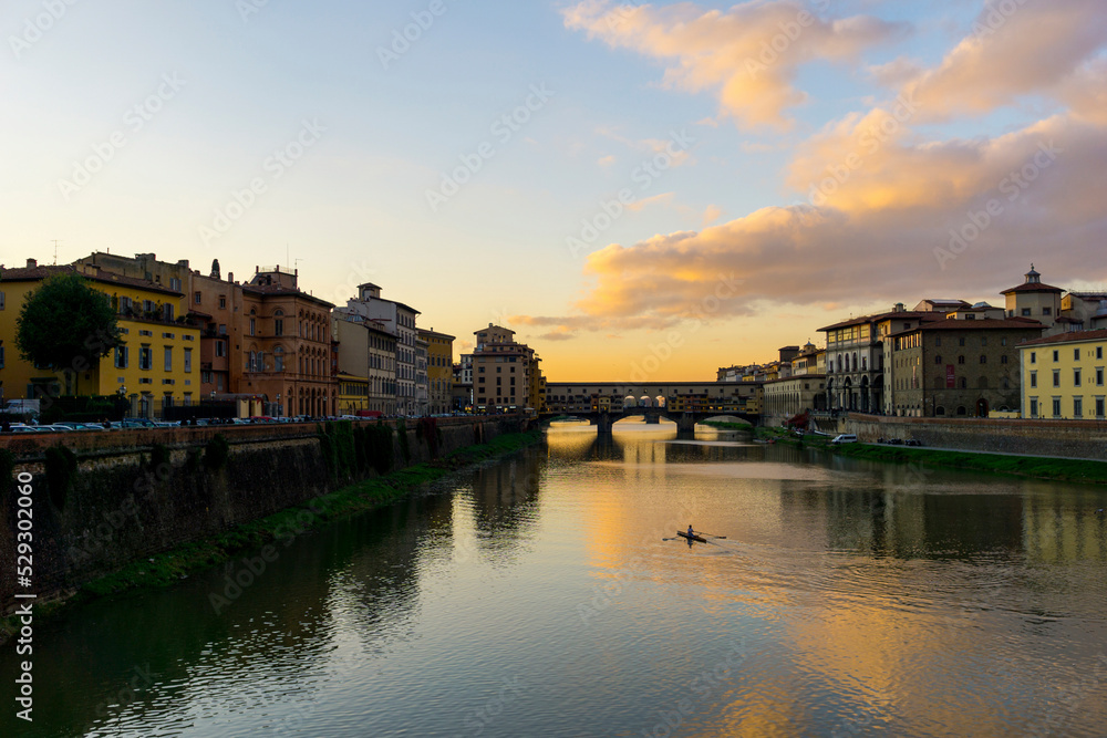 Ponte Vecchio over Arno river against sky during sunset in city Ponte Vecchio over Arno river against sky during sunset in city