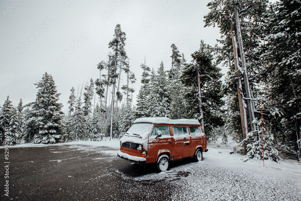 Snow covered van on field against trees Snow covered van on field against trees