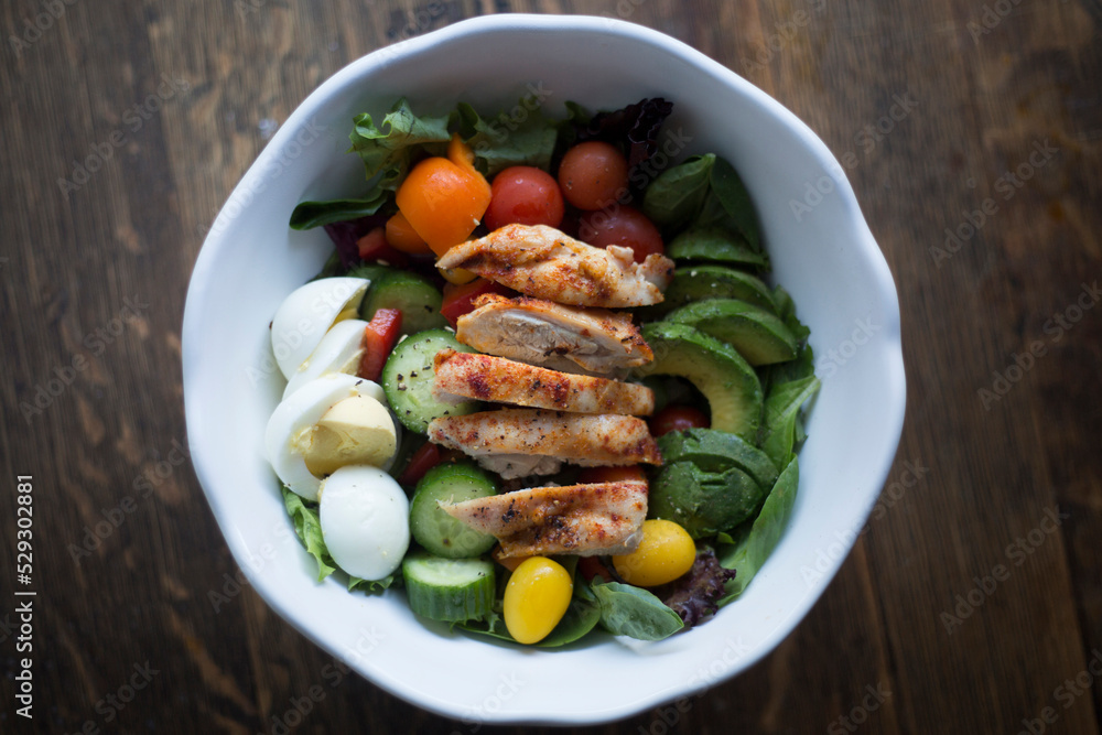 Overhead view of salad served in bowl on wooden table Overhead view of salad served in bowl on wooden table