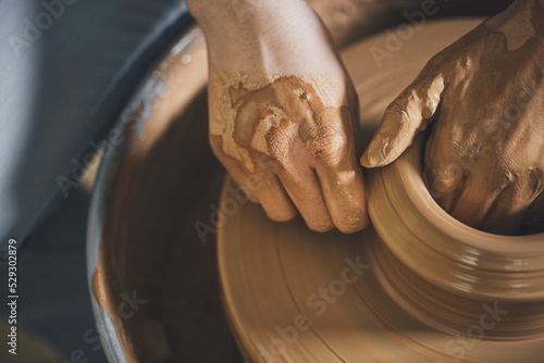 Overhead view of woman working on pottery wheel at workshop