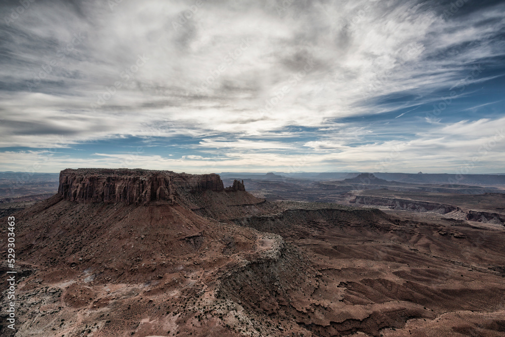 Scenic view of rock formations at Moab against cloudy sky Scenic view of rock formations at Moab against cloudy sky