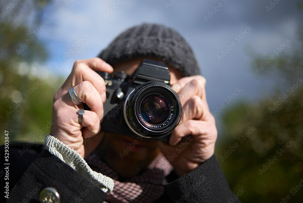 Close-up of man photographing through DSLR camera in Paris