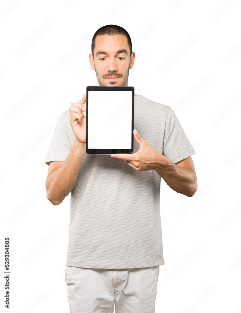 Young man doing gestures using a tablet Young man doing gestures using a tablet