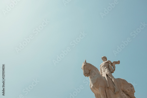 Low angle view of statue against clear sky during sunny day
