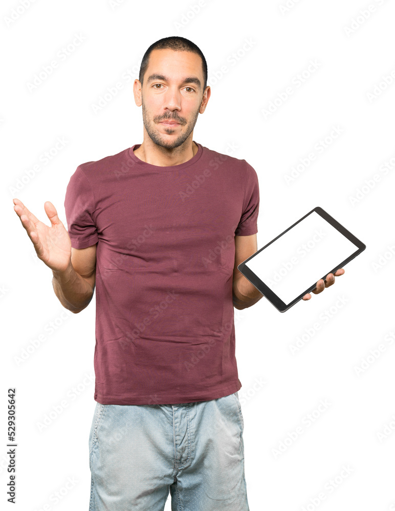 Young man doing gestures using a tablet Young man doing gestures using a tablet