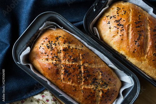 Overhead view of fresh baked breads in baking sheets at home
