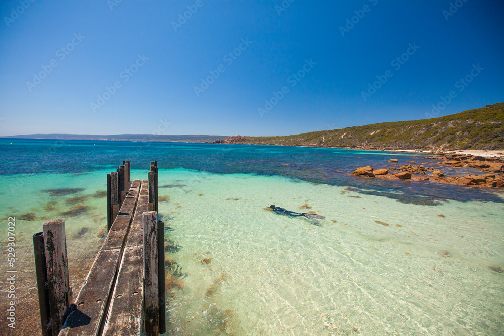 Abandoned wooden pier over sea against clear blue sky during sunny day Abandoned wooden pier over sea against clear blue sky during sunny day