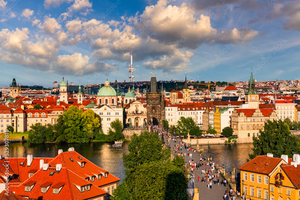 Fototapeta premium Old town of Prague. Czech Republic over river Vltava with Charles Bridge on skyline. Prague panorama landscape view with red roofs. Prague view from Petrin Hill, Prague, Czechia.