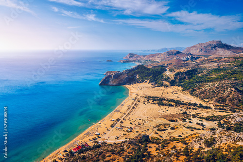 Tsampika beach with golden sand view from above, Rhodes, Greece. Aerial birds eye view of famous beach of Tsampika, Rhodes island, Dodecanese, Greece