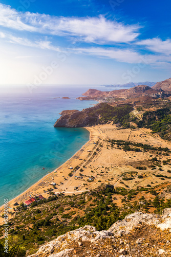 Tsampika beach with golden sand view from above, Rhodes, Greece. Aerial birds eye view of famous beach of Tsampika, Rhodes island, Dodecanese, Greece