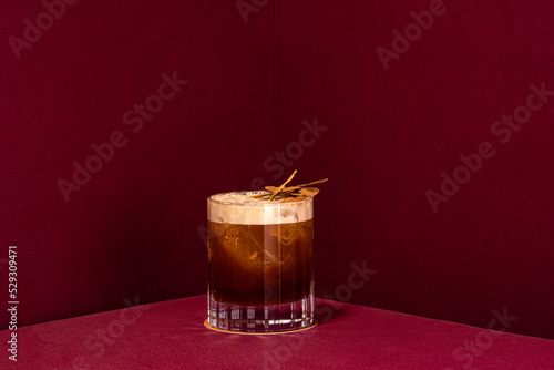 Billede på lærred carajillo cocktail, cold coffee drink on a red background served in an old fashi